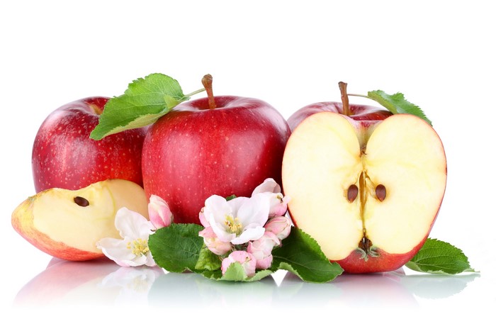 Red apples with flowers and leaves on white background