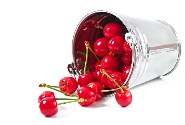 Cherries spilling from a bucket