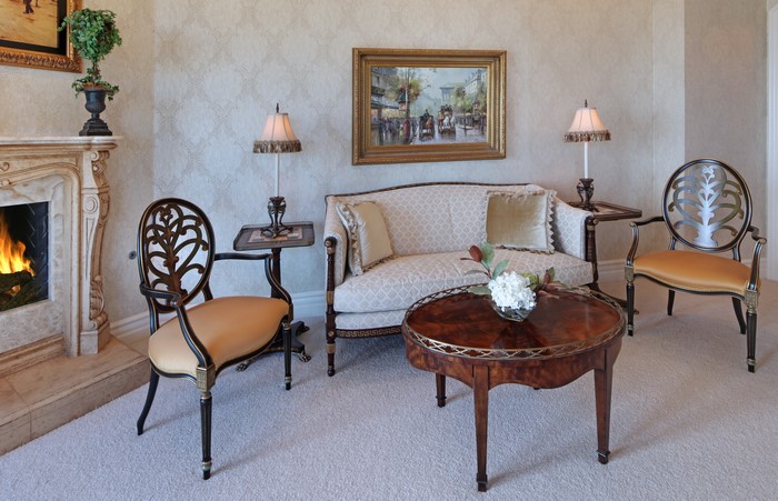 Living room with sofa, chairs, coffee table, and fireplace