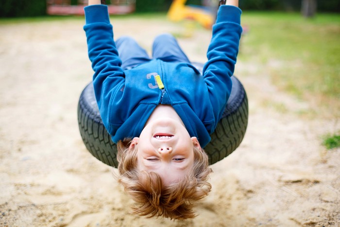 Boy on a tire swing