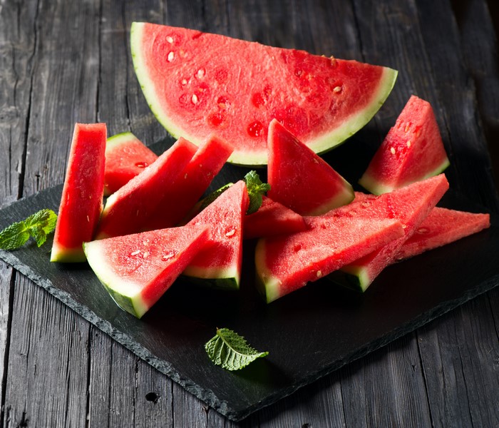 Watermelon slices on a dark wooden table