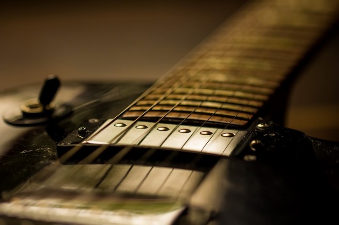 Close-up of an electric guitar neck and strings