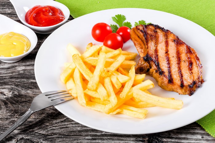 Grilled Pork Chop with French Fries and Tomatoes