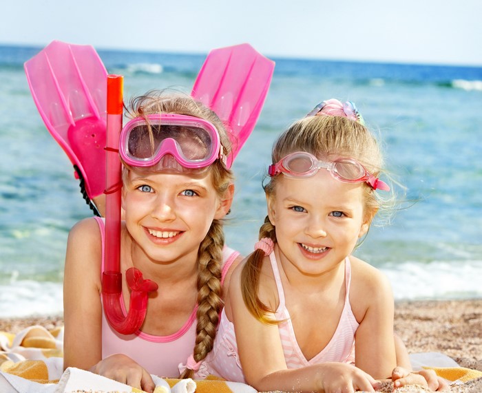 Two Smiling Girls at the Beach with Snorkeling Gear