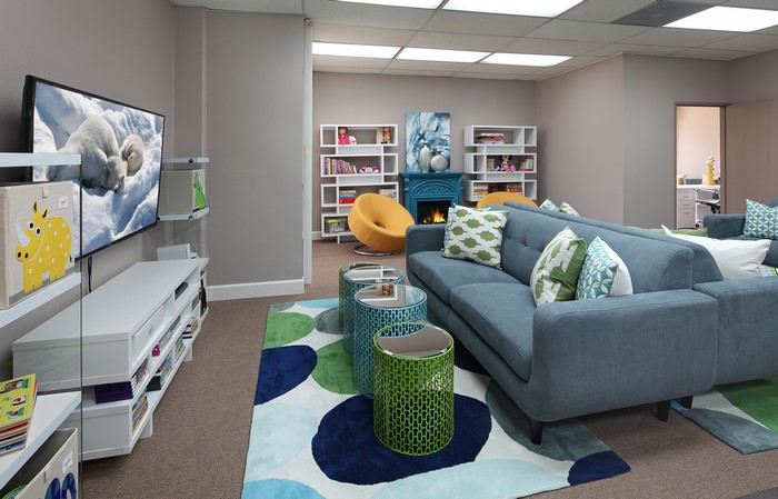 Living room with sofa, TV, and bookshelves
