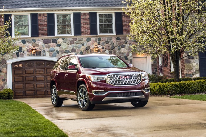 GMC Acadia SUV parked in front of a house