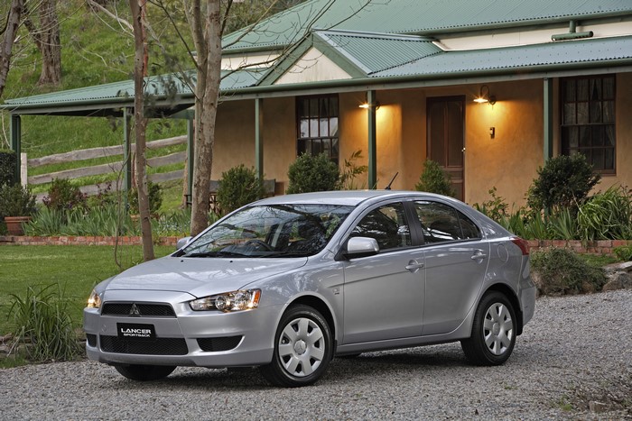 Silver Mitsubishi Lancer ES Sportback parked in front of a house