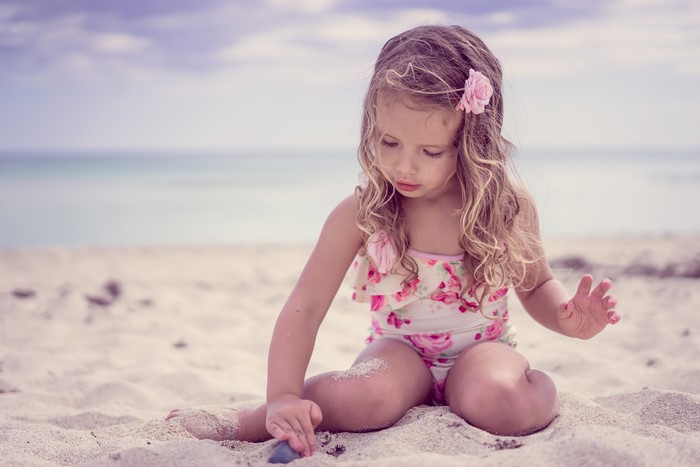 Little girl playing on the beach