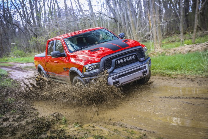 Red Ram 1500 Rebel Crew Cab driving through mud