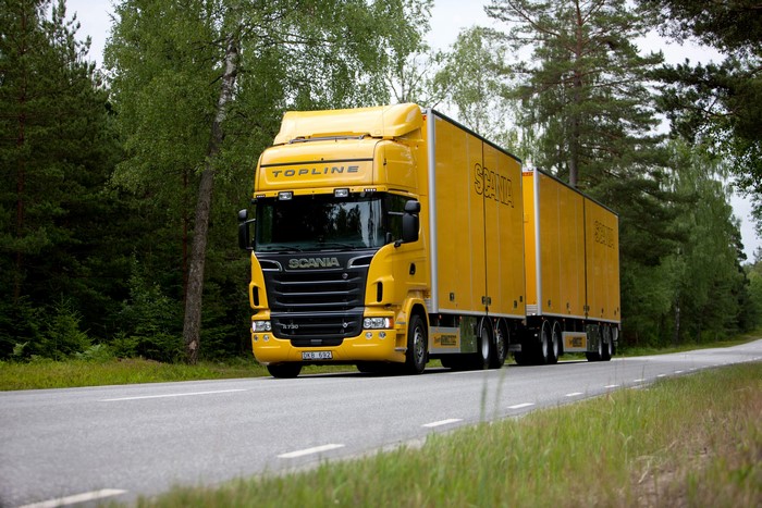 Yellow Scania Truck with Trailers on a Road