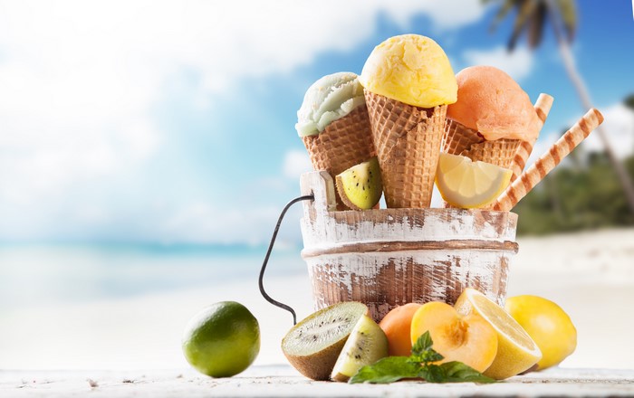 Ice cream cones with fruits on a beach