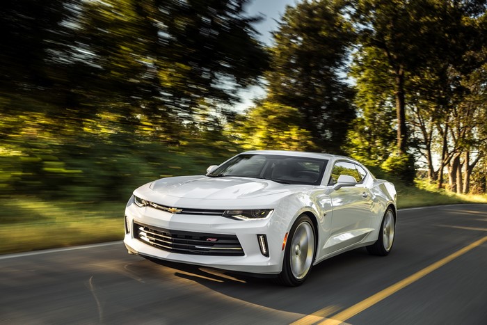 White Chevrolet Camaro RS driving on a road