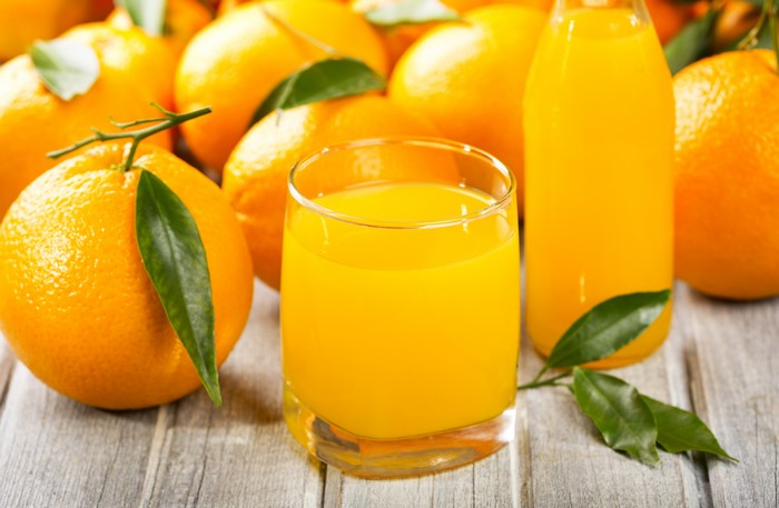 Oranges and orange juice in a glass and bottle
