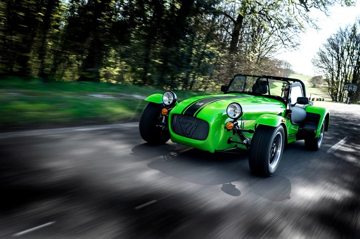 Green Caterham 7 275 R driving on a road