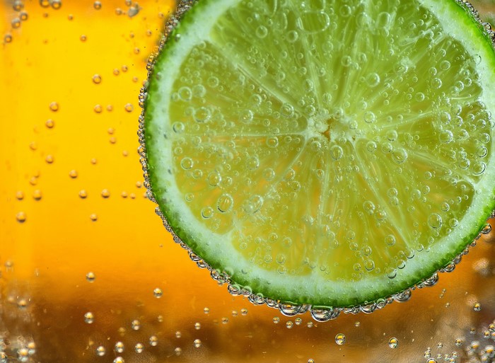Lime slice in sparkling orange liquid