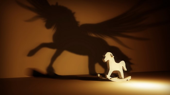 Rocking horse casting a shadow of a winged horse