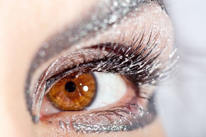 Macro shot of a human eye with glitter makeup