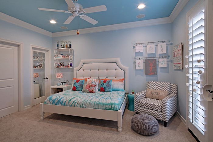 Bedroom with blue ceiling and white bed