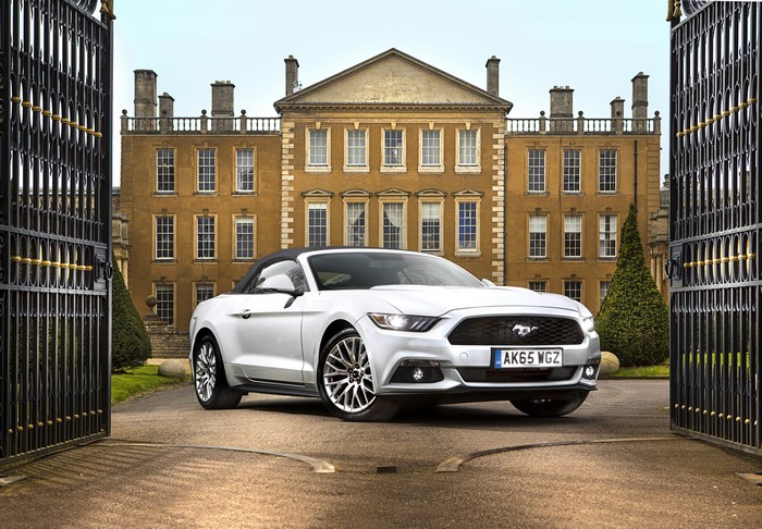 White Ford Mustang GT Convertible in front of a mansion