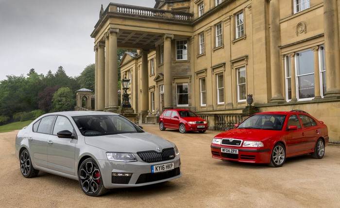 Three Skoda cars parked in front of a mansion