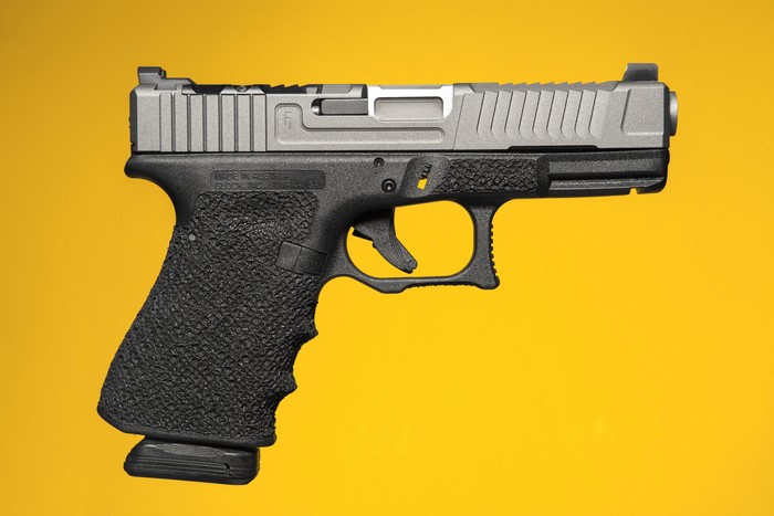 Glock pistol with custom slide and grip