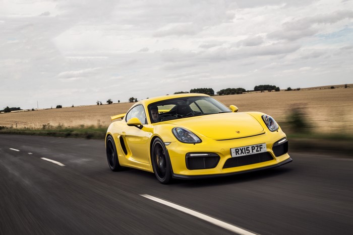Yellow Porsche Cayman GT4 on a Road