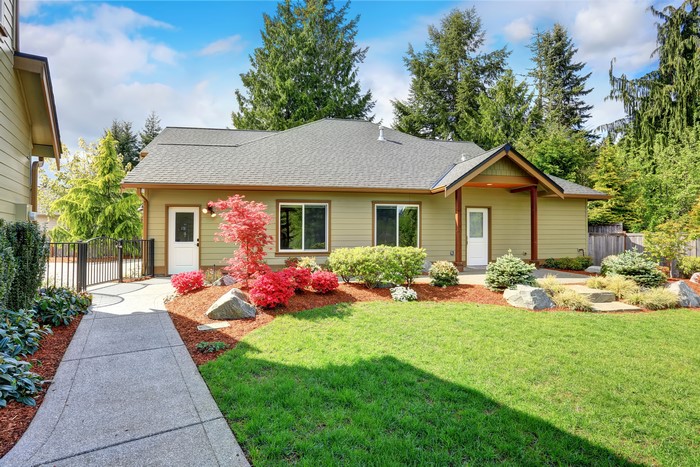 House with lawn and shrubs