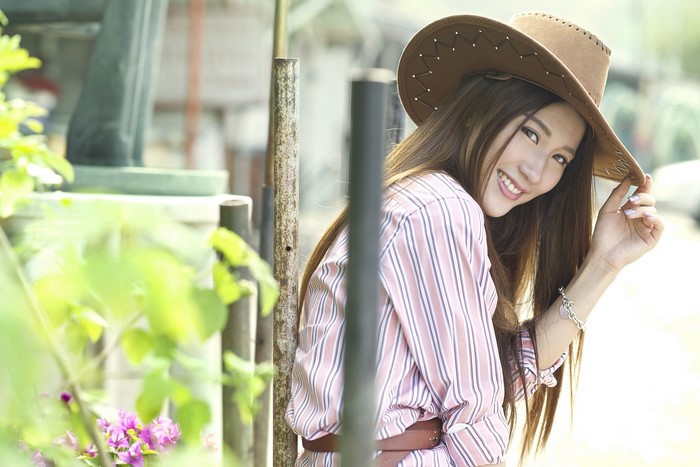 Woman in cowboy hat and striped shirt