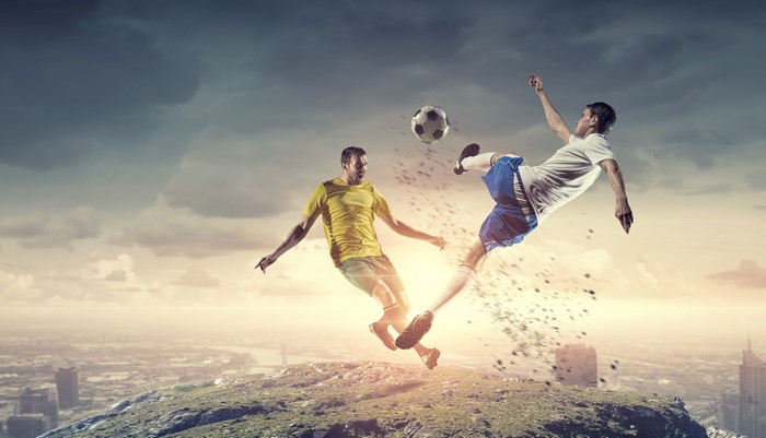 Two men playing soccer in the air