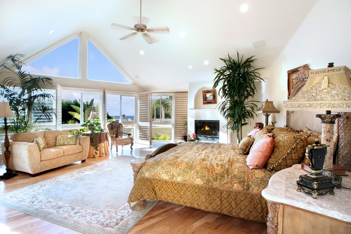 Luxury bedroom with fireplace and ocean view
