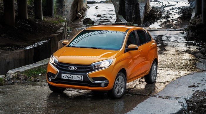 Orange Lada XRAY car on a wet road