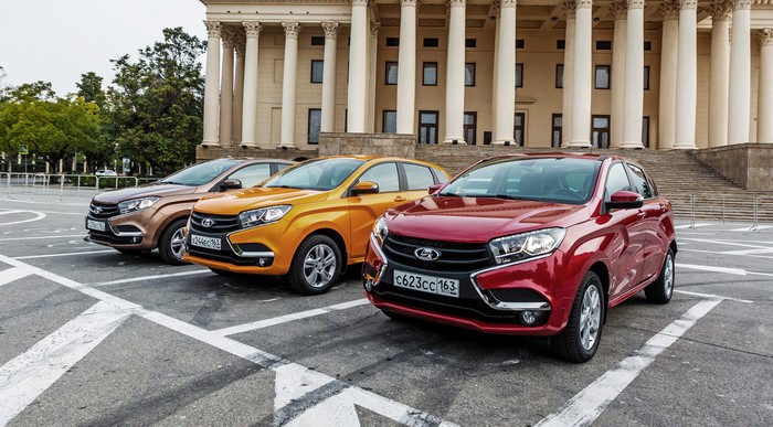 Three Lada XRAY cars parked in front of a building