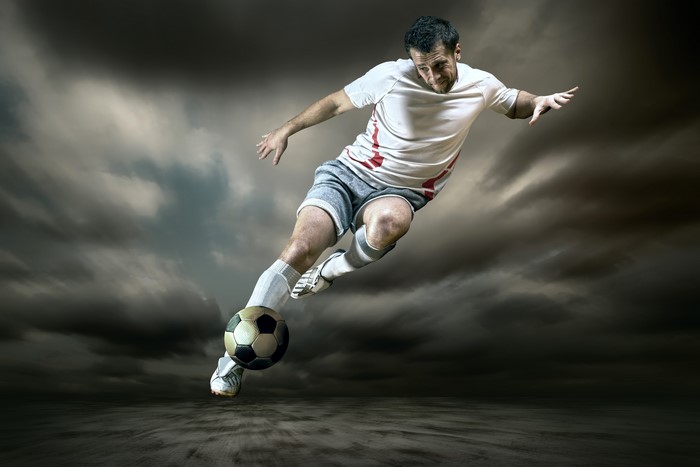 4K Action Shot of Football Player Kicking Ball