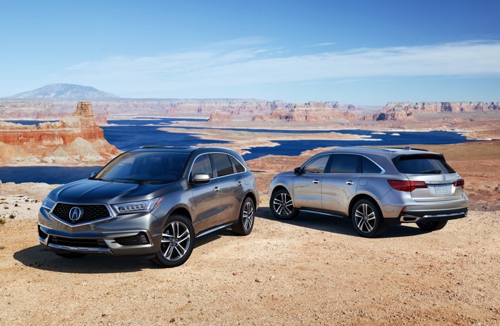 Two 2017 Acura MDX SUVs in a desert landscape