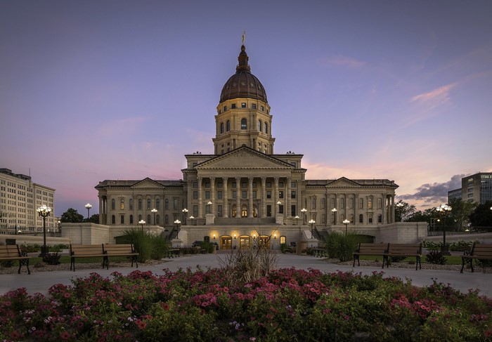 Kansas State Capitol Building at Dusk with Flowers and Benches
