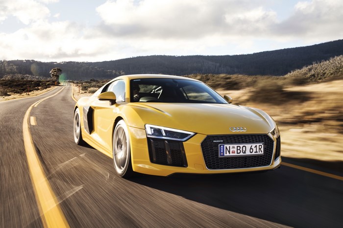 Yellow Audi R8 V10 driving on a road