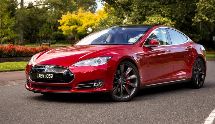 Red Tesla Model S P85D parked on a street