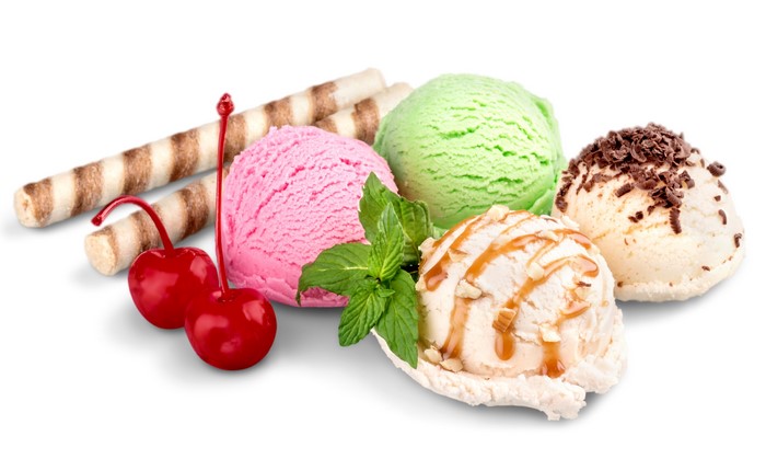 Ice cream scoops with cherries and wafer rolls