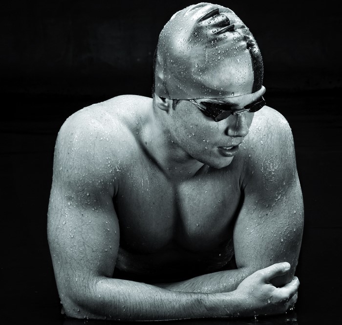 Swimmer with goggles and cap covered in water drops