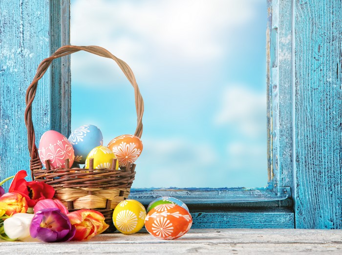 Easter eggs in a basket with tulips