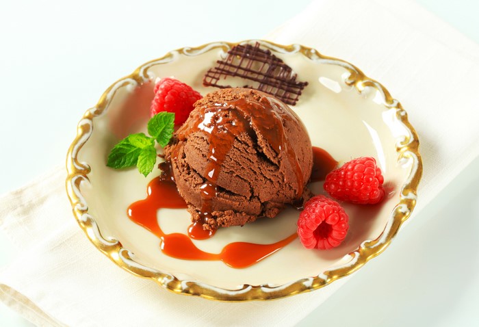 Chocolate ice cream with raspberries and caramel sauce