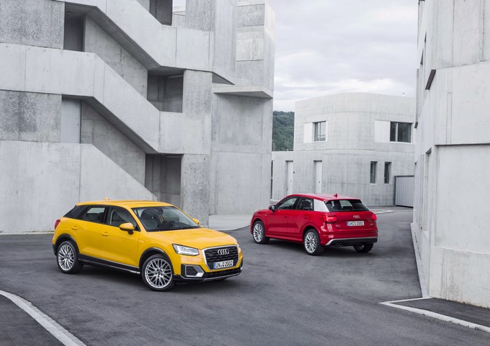 Two Audi Q2 cars in a modern architectural setting