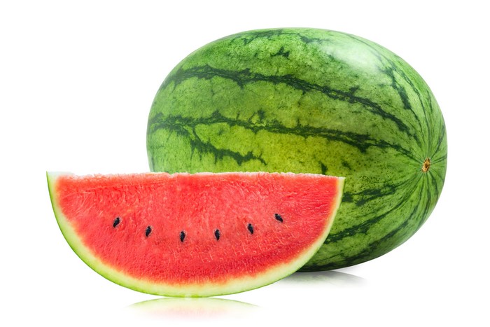 Watermelon slice and whole watermelon on white background