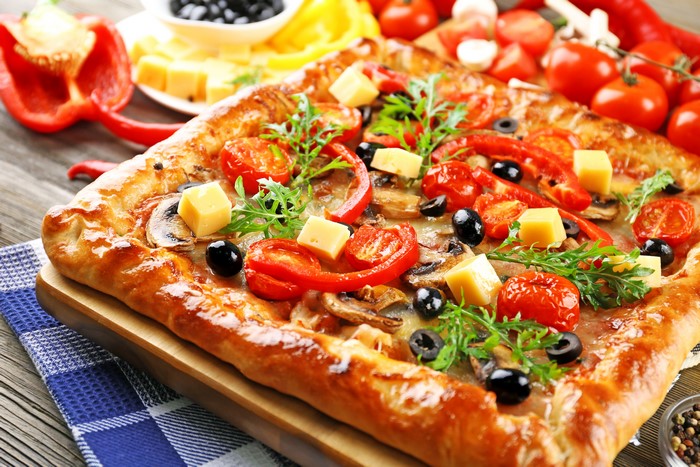 Rectangular pizza with vegetables and cheese