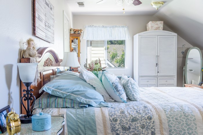 Bedroom with bed, pillows, and closet