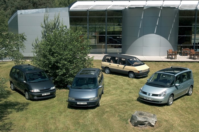 Four Renault Espace minivans parked on grass