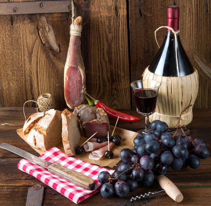 Still-life with Ham, Grapes, Bread, Wine, and Chili Pepper