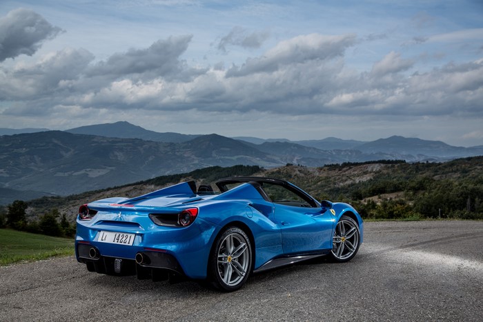 Blue Ferrari 488 Spider convertible in mountains