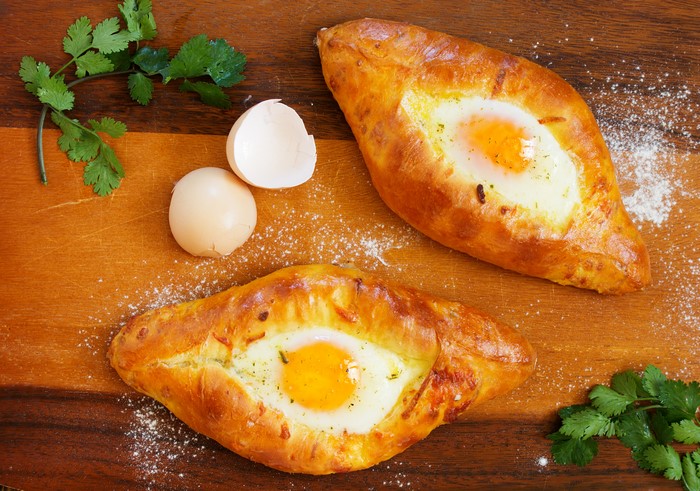 Two Khachapuri with Fried Eggs and Cilantro