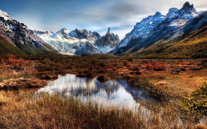 Mountain range with glacier and lake in autumn
